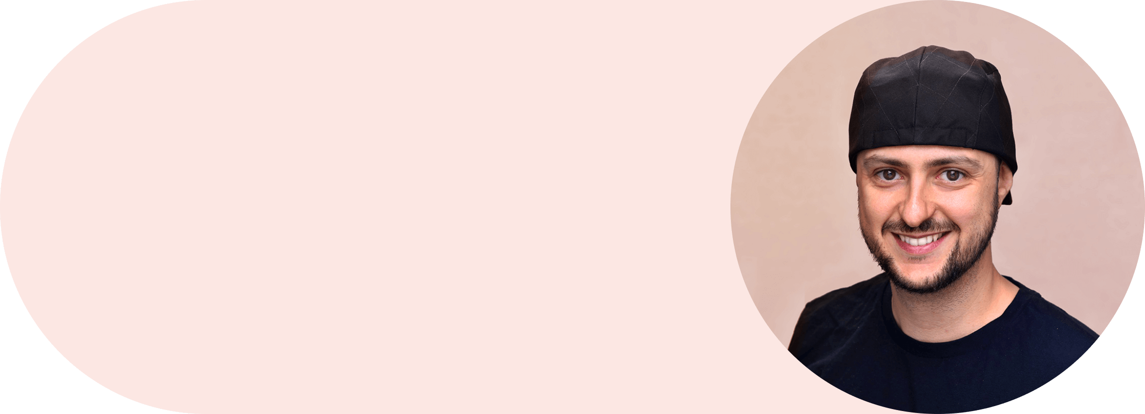 Smiling Andrés Rigo portrait looking at the camera. He is wearing black shirt and a cap