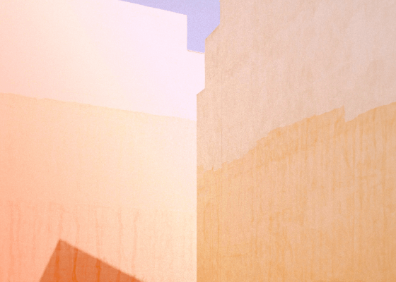 Detail of a building where two facades encounters in the middle casting a small triangle shadow