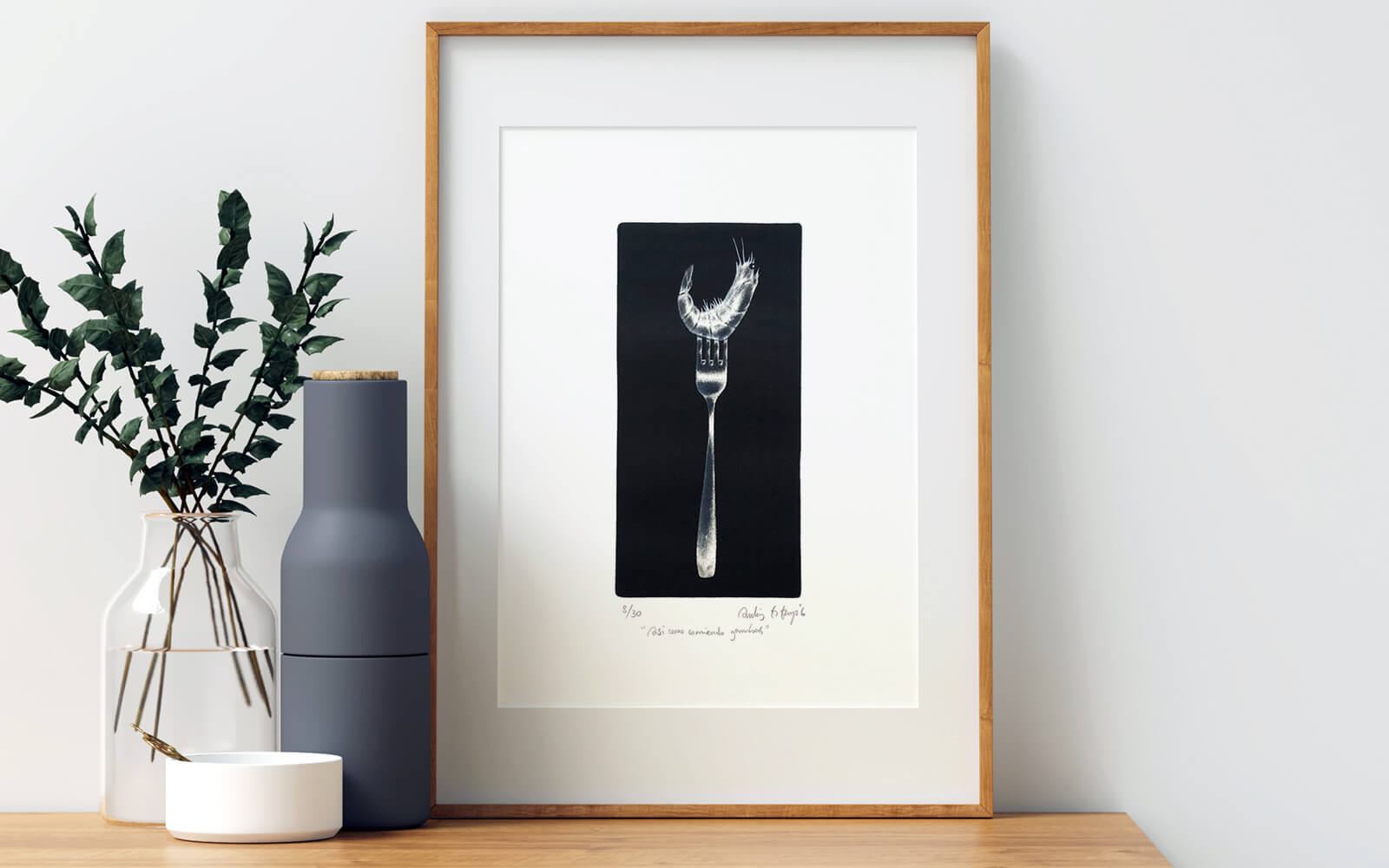 Artwork framed on a canvas, surrounded by home decoration such plants and a bottle of water