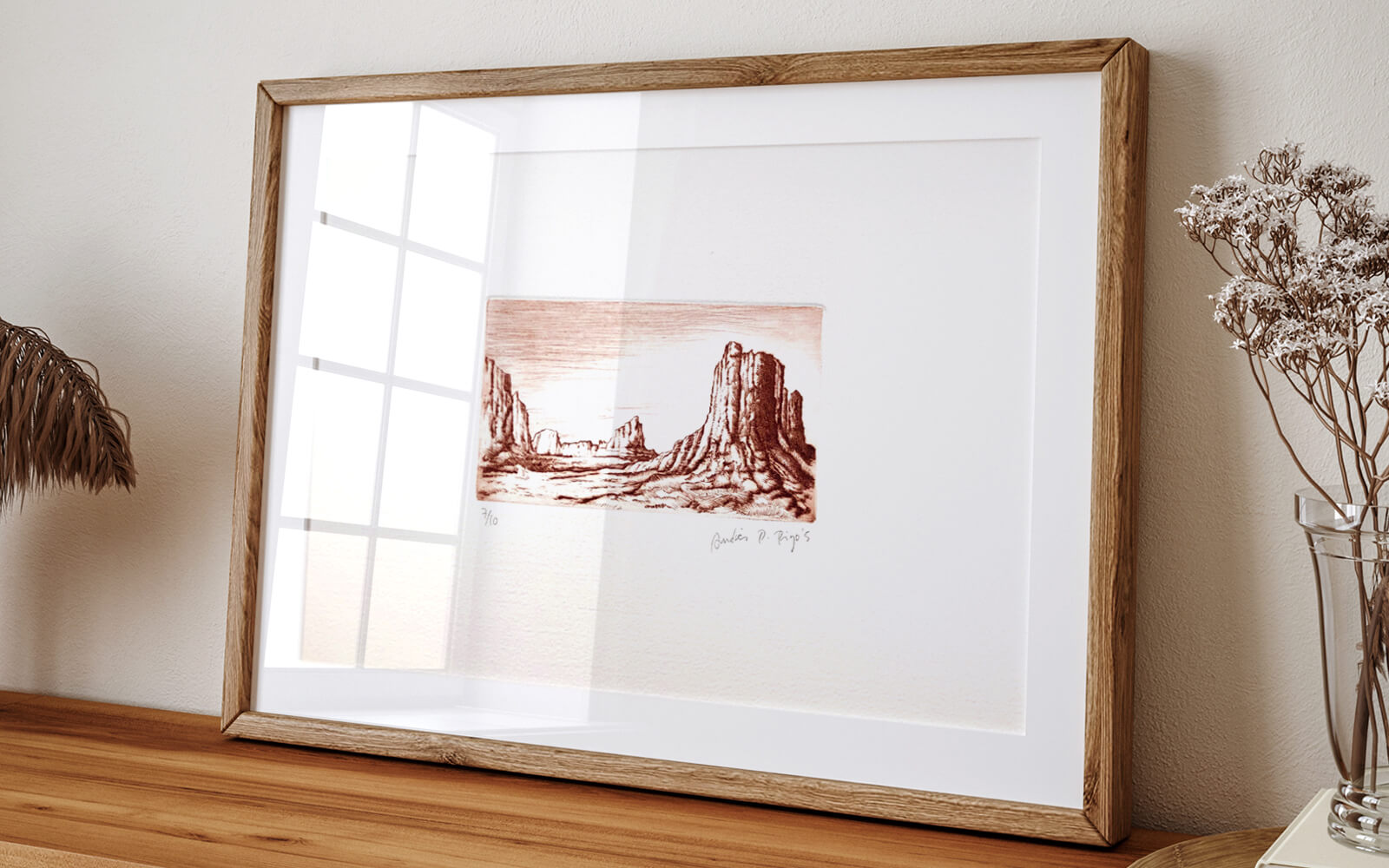 Drawing of the Colorado mountains printed on paper and placed in a wooden frame in a home environment