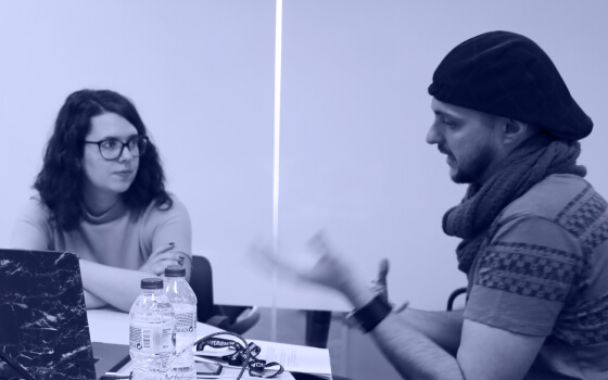 Andrés chats about a project with a colleague